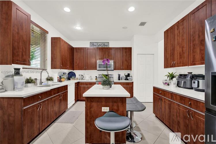 A kitchen with wooden cabinets and a white countertop.
