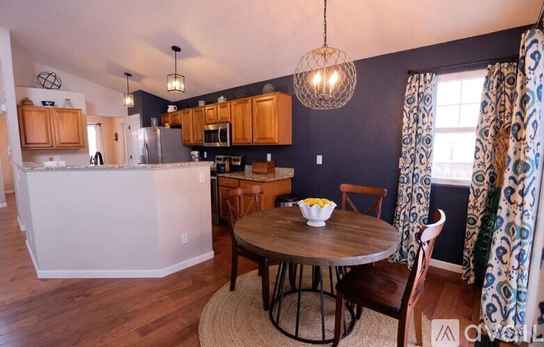 A kitchen with a table and chairs in the middle of the room.