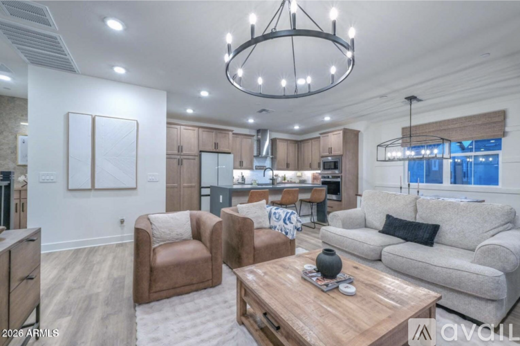 A modern living room with a wooden coffee table and two brown armchairs.