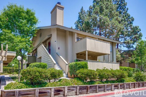 A modern house with a wooden fence in front.