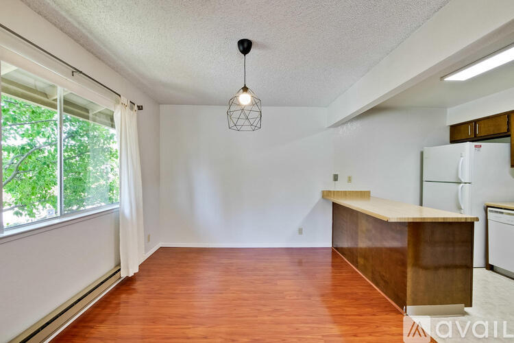 A kitchen with a wooden counter and white appliances.