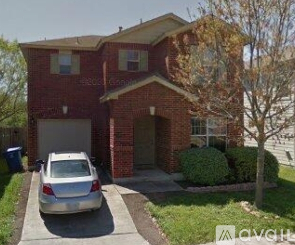 A house with a car parked in front.