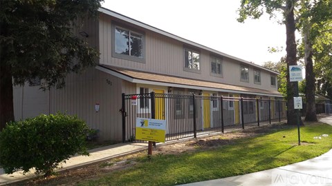 A building with a yellow sign in front of it.