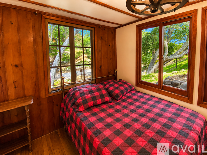 A bedroom with a bed and a window.