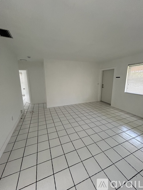 A room with white walls and a white tile floor.