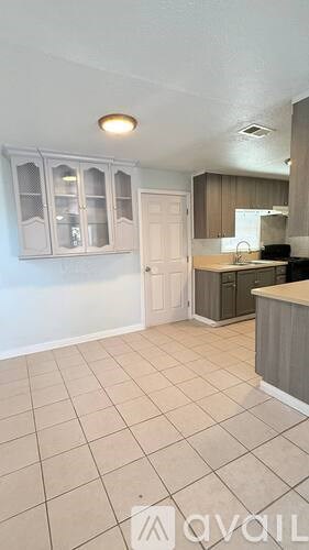 A kitchen area with a counter and cabinets.