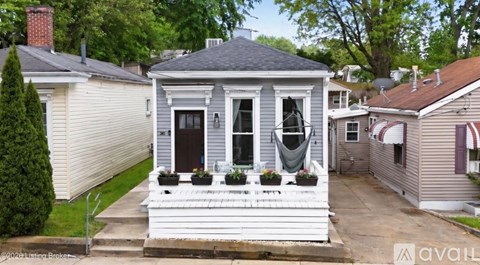 A house with a front porch and a small garden.