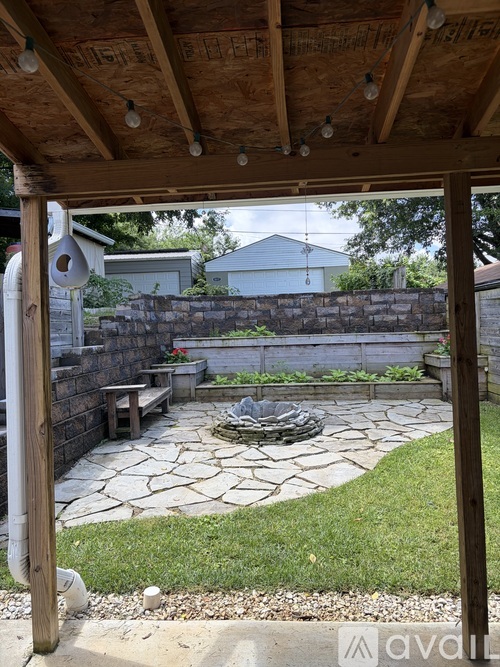 A patio with a stone walkway and a fire pit.