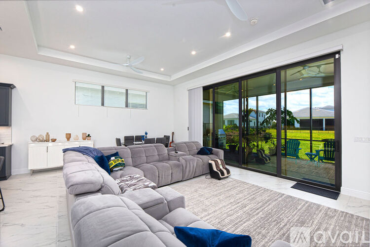 A living room with a grey sofa and a television.