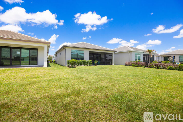 A row of houses with a grassy lawn in front.