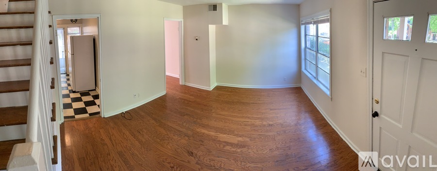 A room with wooden floors and a checkered floor in the corner.