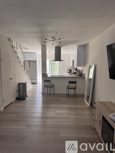 A modern kitchen with a dining table and chairs.