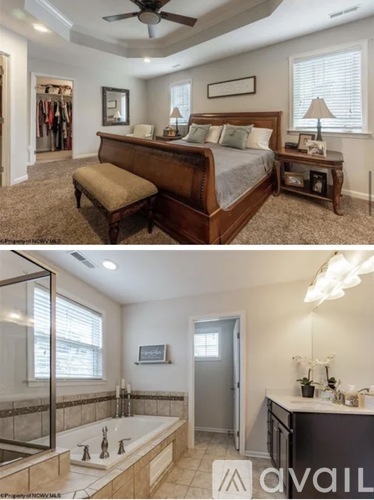 A bedroom with a large bed and a bathroom with a jacuzzi tub.