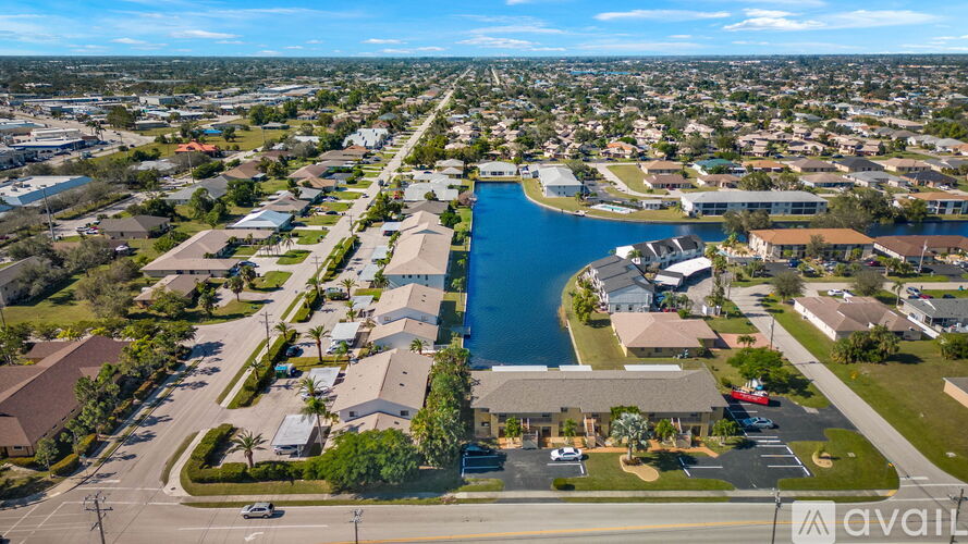 A bird's eye view of a residential area with a large blue water body in the center.