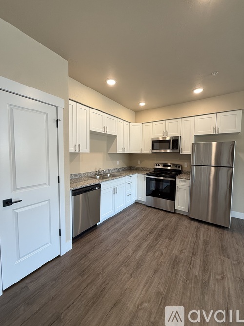 A kitchen with white cabinets and stainless steel appliances.