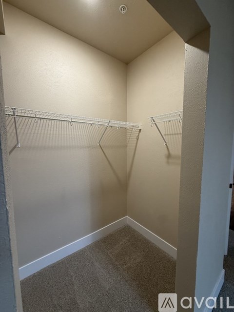 A small, empty room with two wire shelves.