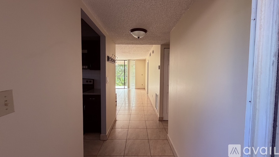 A long hallway with a door on the right.