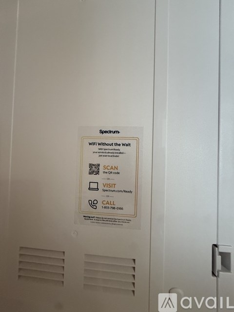 A sign on a wall that says "Spectrum" and "WiFi without the Wait".