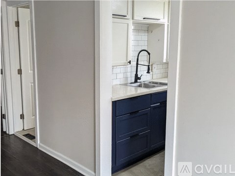 A kitchen with a sink and a counter.