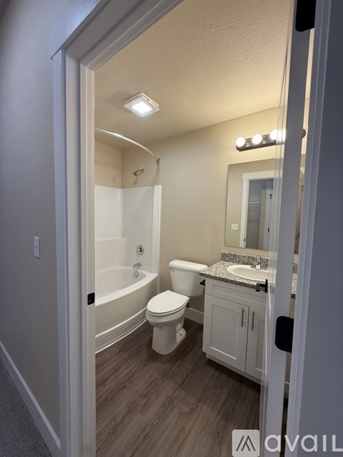 A bathroom with a toilet, sink, and bathtub.