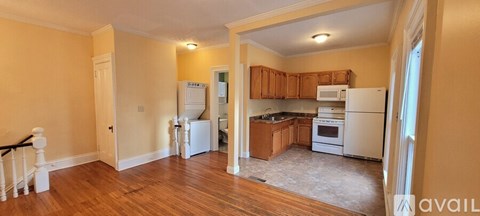 A kitchen with wooden cabinets and a white refrigerator.
