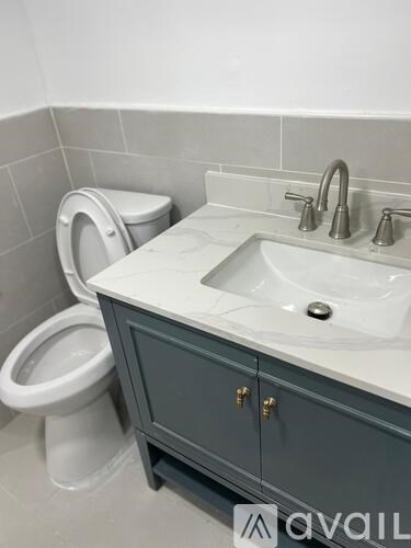 A bathroom with a toilet and sink.