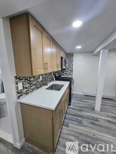 A kitchen with wooden cabinets and a white countertop.