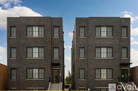Two identical brick buildings with windows and doors.