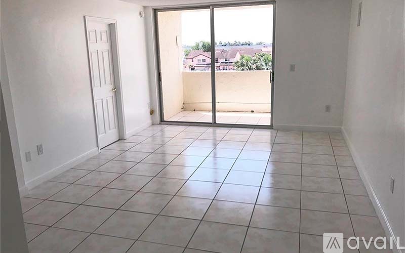 A room with a sliding glass door leading to a balcony.