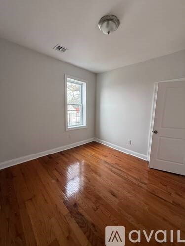 A room with wooden floors and a window.