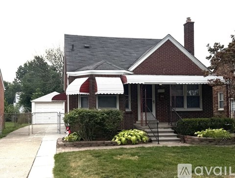 A red brick house with a white roof and a white garage door.