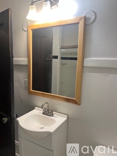 A bathroom with a sink and mirror.