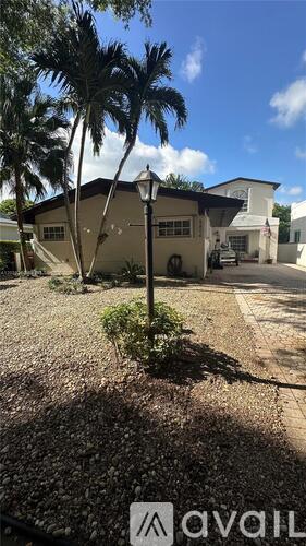 A house with a palm tree in front of it.