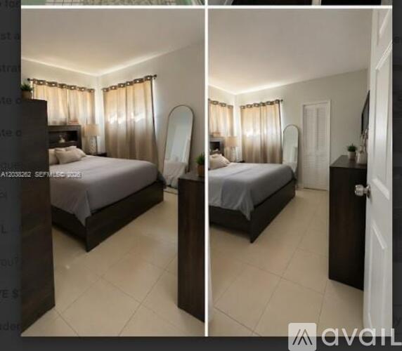 A bedroom with a bed, dresser, and mirror.
