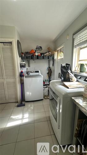 A kitchen with a white dishwasher and a white microwave.