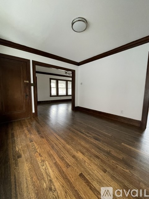 A room with wooden floors and white walls.