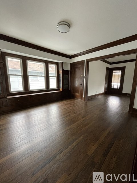 A room with wooden floors and a window.