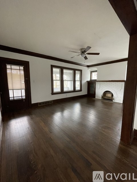 A room with wooden floors and a ceiling fan.