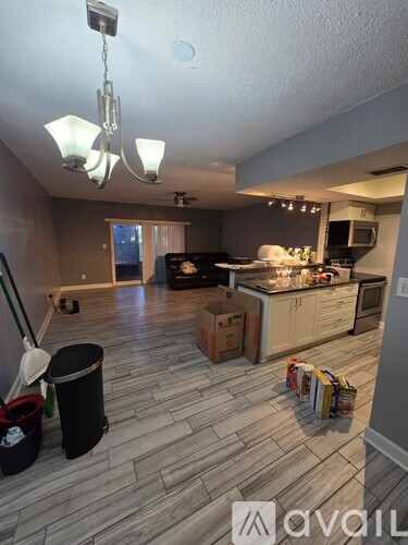 A kitchen with a dining table and chairs in the middle of the room.