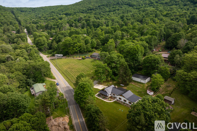 A bird's eye view of a house surrounded by greenery.