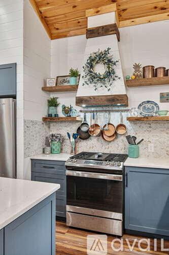 A kitchen with a stove top oven and a range hood.