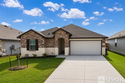 A house with a garage and a driveway is for sale.