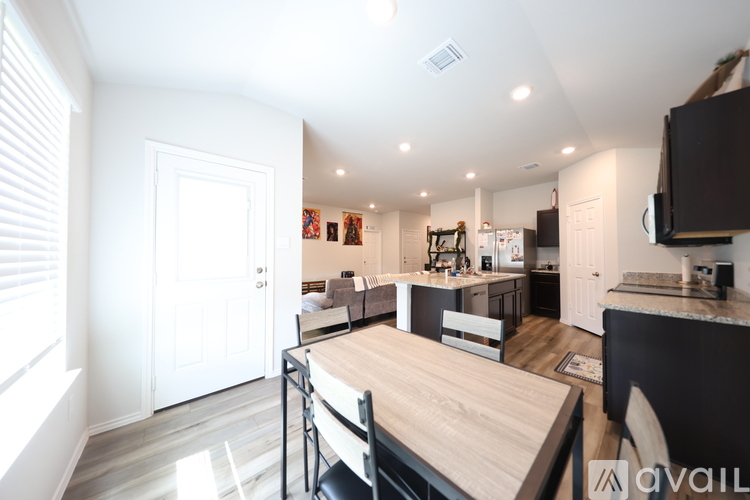 A kitchen with a table and chairs in the middle of the room.