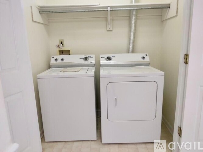 A small bathroom with a washer and dryer.