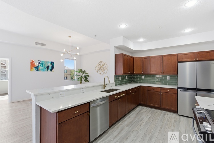 A modern kitchen with wooden cabinets and stainless steel appliances.