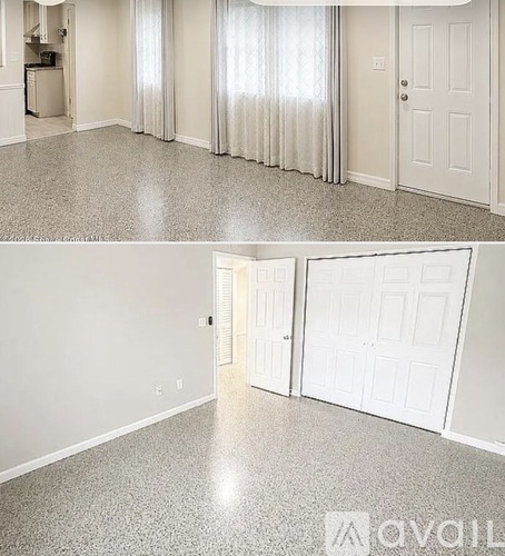 A spacious room with a glittery floor and white walls.