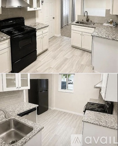 A kitchen with black appliances and white cabinets.