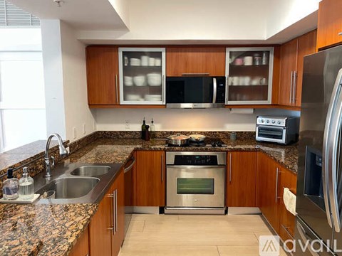 A kitchen with wooden cabinets and granite countertops.
