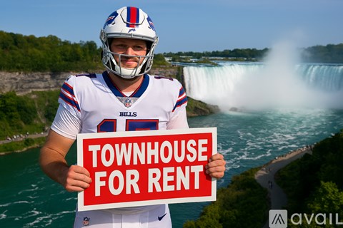 A man in a Buffalo Bills jersey holds a sign offering a townhouse for rent.