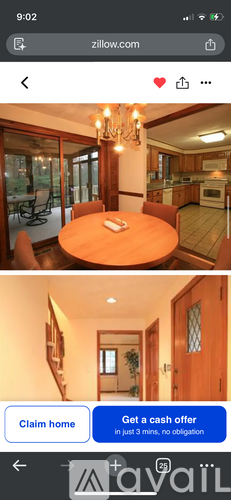 A dining room with a wooden table and chairs.